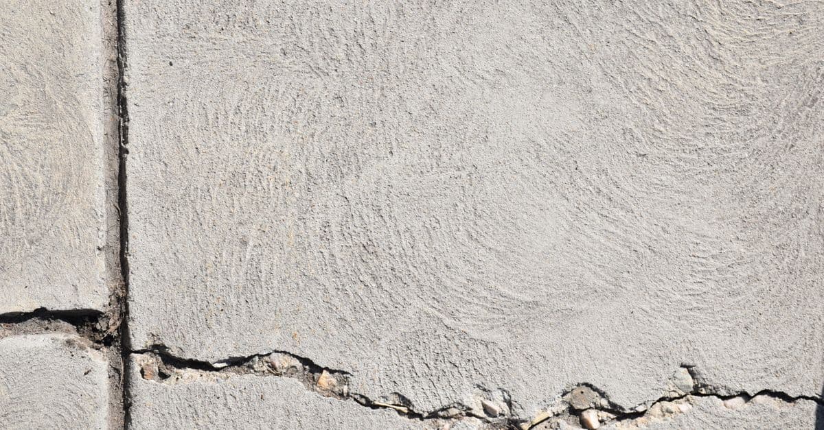 Close-up view of a cracked concrete surface with distinct textures in Logan, Utah.